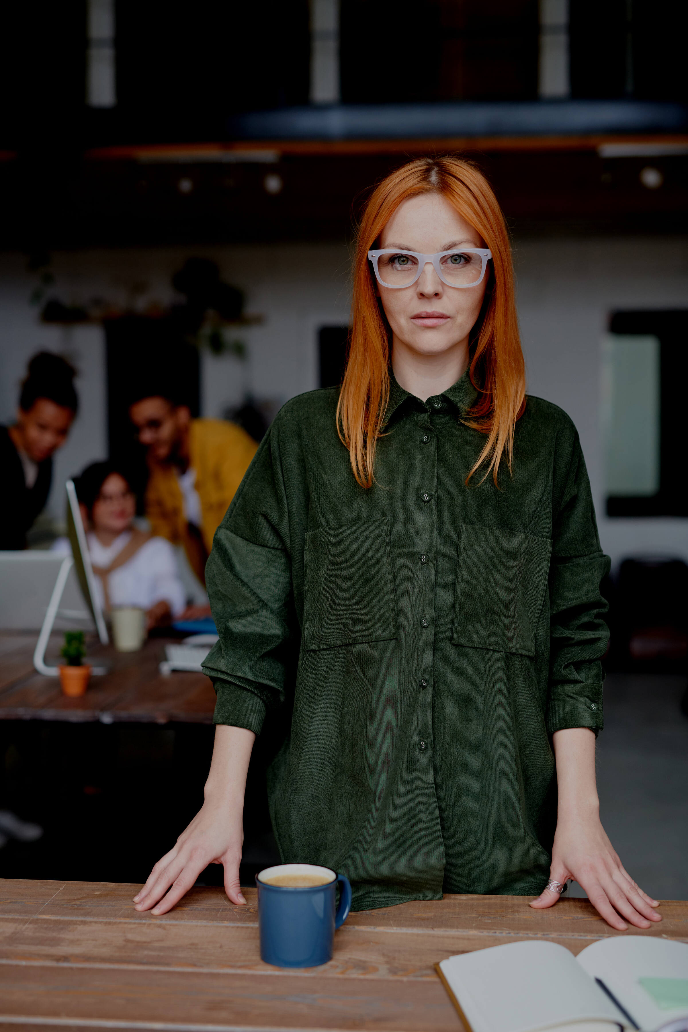 Woman in Green Collared Long-sleeved Top Standing Indoors